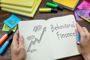 Behavioral finance is shown on a business photo using the text